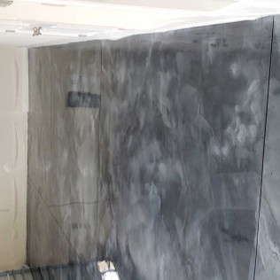 Distressed gray painted cabinet doors with artistic weathered finish showing texture and depth