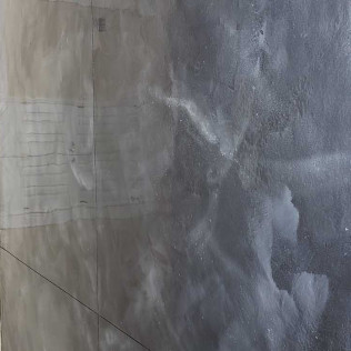 Close-up of metallic epoxy flooring showing swirled gray and white marble-like pattern with glossy surface