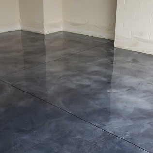 Completed metallic epoxy floor in empty room with gray marbled pattern and mirror-like reflective finish