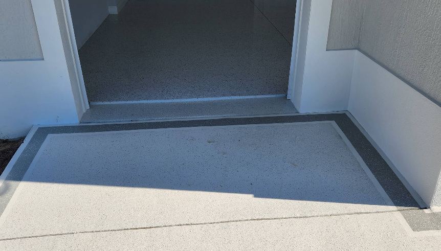 Painted concrete landing with light gray center and darker gray border at home entrance